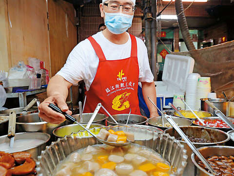 人稱「毛巾頭」的老闆不停歇地挖著一碗接一碗冰。（攝影／岩武栩）