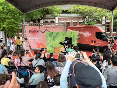 北市圖行動書車邀請臺北市人氣吉祥物熊讚代言書車，照片為書車啟動儀式中熊讚出場的時候，從出場的尖叫聲就可以知道熊讚的魅力有多強