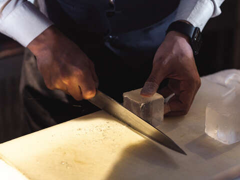 The sharply-dressed bartender shows-off his ice cutting skills, with the bar having a high standard for presentation, even when it comes to ice cubes.