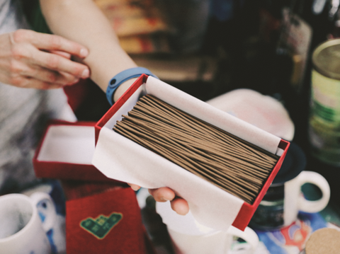 These incense sticks are made with formulas handed down within the family, with the founder’s photo printed on the package. (Photo/Dinghan Zheng)
