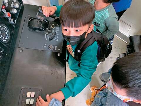小朋友樂此不疲地在逃生體驗營中試玩機關、按鈕。（圖／可大王）