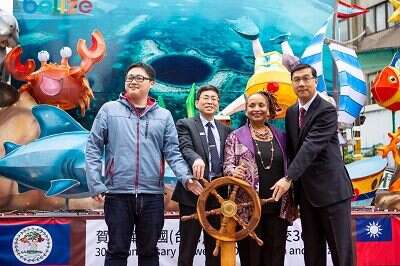 外交部、大使馆与台北市政府共同为「潜进大蓝洞，探索贝里斯」转动船舵。