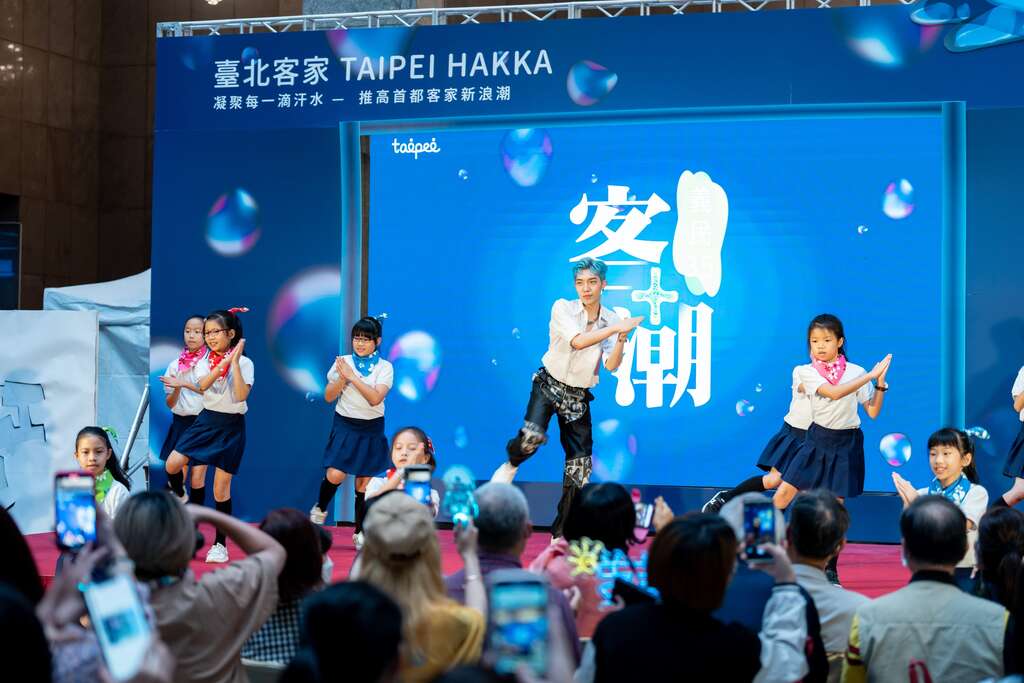 原子少年蓝弟与国小小朋友共舞(图片来源：台北市政府客家事务委员会)