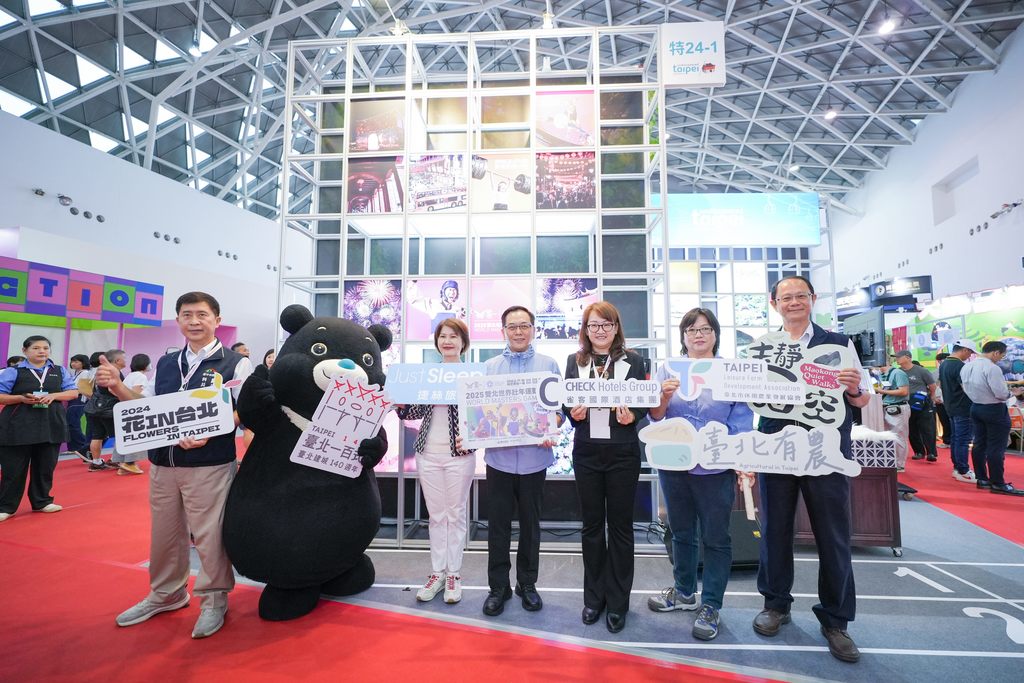 臺北市政府觀光傳播局專門委員沈永華（左四）、臺北城市吉祥物熊讚（左二）與臺北館參展業者共同啟動臺北館開幕儀式。(圖片來源：臺北市政府觀光傳播局)